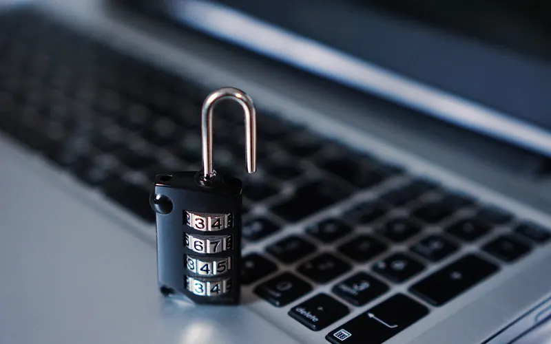 Combination padlock standing on a laptop keyboard